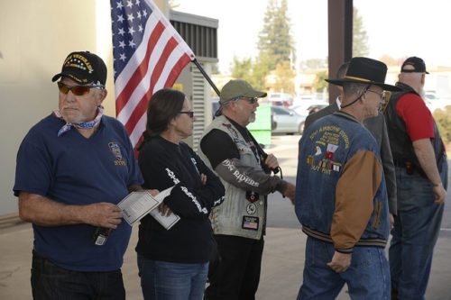 Veterans gathered and holding an American flag